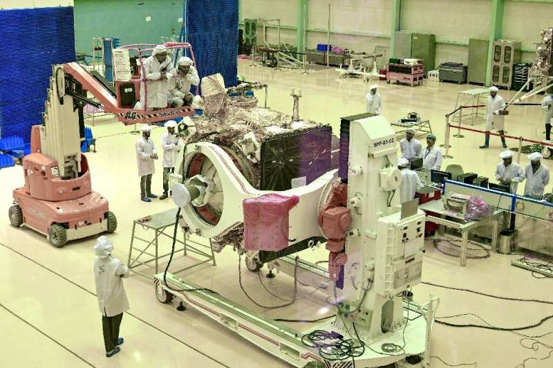 Scientists work on the orbiter vehicle of Chandrayaan-2, India's first moon lander and rover mission