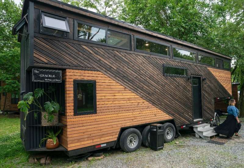 Scott Berrier's tiny home, known as Grackle, is on wheels—his wife Melissa is pictured outside