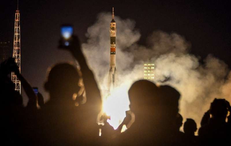 The Soyuz rocket carrying three crew members of the International Space Station blasts off