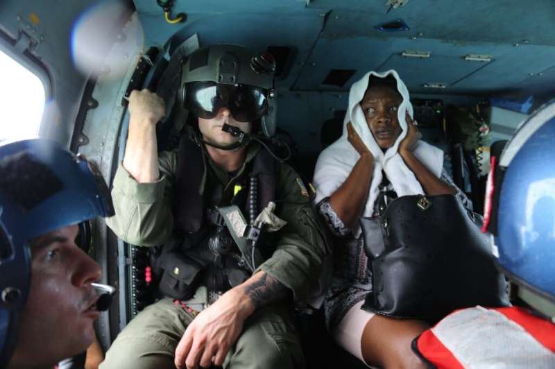 The US Coast Guard evacuates a survivor from Hurricane Dorian after rescuing her from Treasure Cay, Bahamas