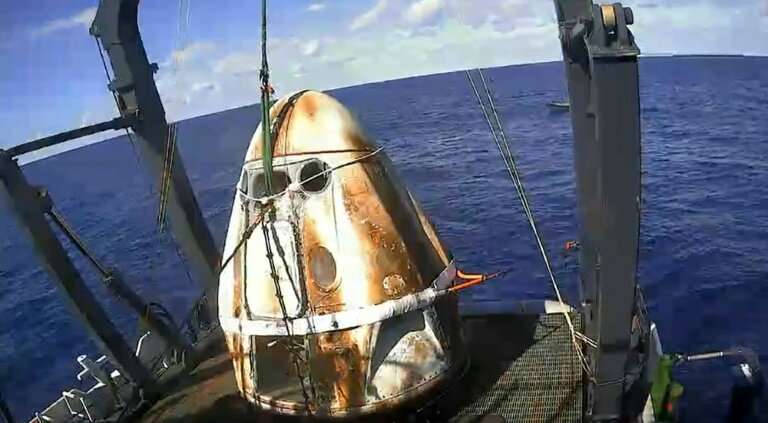 This still image taken from NASA TV shows SpaceX's Crew Dragon spacecraft safely aboard the company's recovery vessel following 