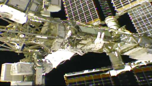 Spacewalking astronauts tackle battery, cable work