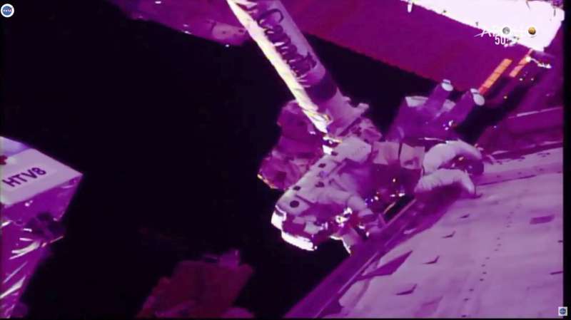 Spacewalking astronauts slice into cosmic ray detector (Update)