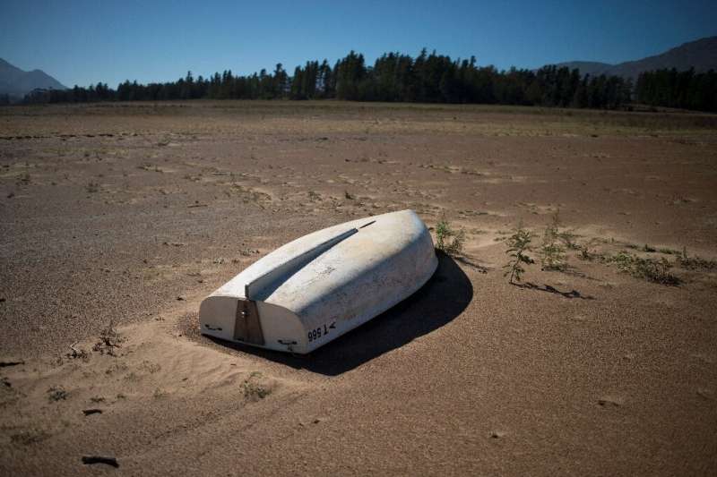 A picture taken on May 10, 2017 shows a boat lying on the sand at the Theewaterskloof Dam, which has less than 20% of it's water