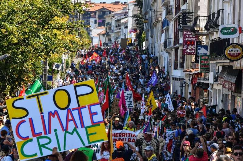 Demonstrators take part in a climate march in Hendaye, south-west France on August 24, 2019, to protest against the annual G7 Su