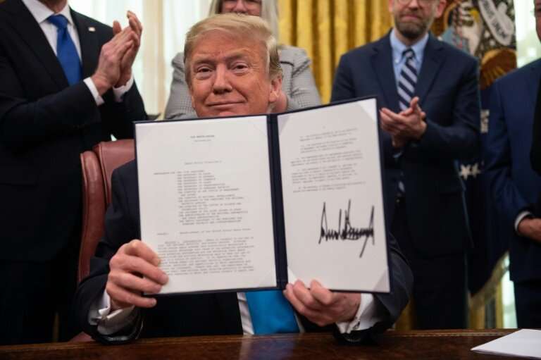 US President Donald Trump shows his signature on the Space Policy Directive-4 (SPD-4) on February 19, 2019 at the White House—he