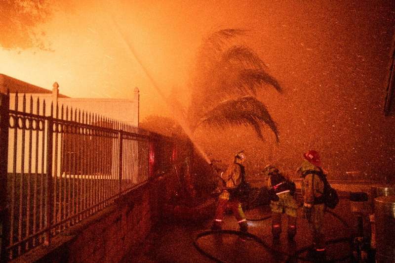 Firefighters battle wind-whipped flames engulfing multiple homes during the Hillside Fire in the North Park neighborhood of San 