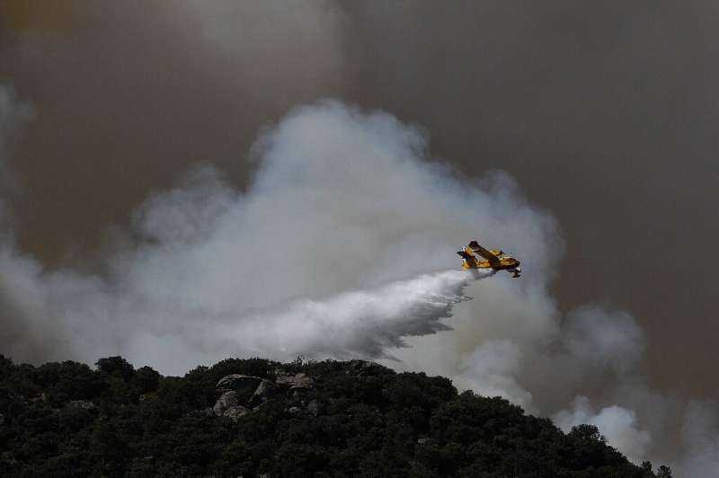 Firefighters in Spain battled high flames in strong winds and blistering heat just after they managed to contain another inferno