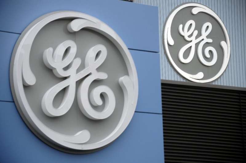 General Electric raised its full-year profit forecast despite reporting a second-quarter loss