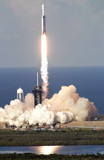 SpaceX launches mega rocket, lands all three boosters