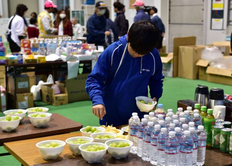 Typhoon Hagibis forced tens of thousands of people to flee their homes, including this boy taking fruit at a shelter in Nagano