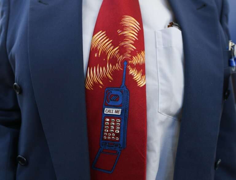 A bidder wearing depicting a ringing mobile phone at the start of Germany's auction for the construction of its ultra-fast 5G mo