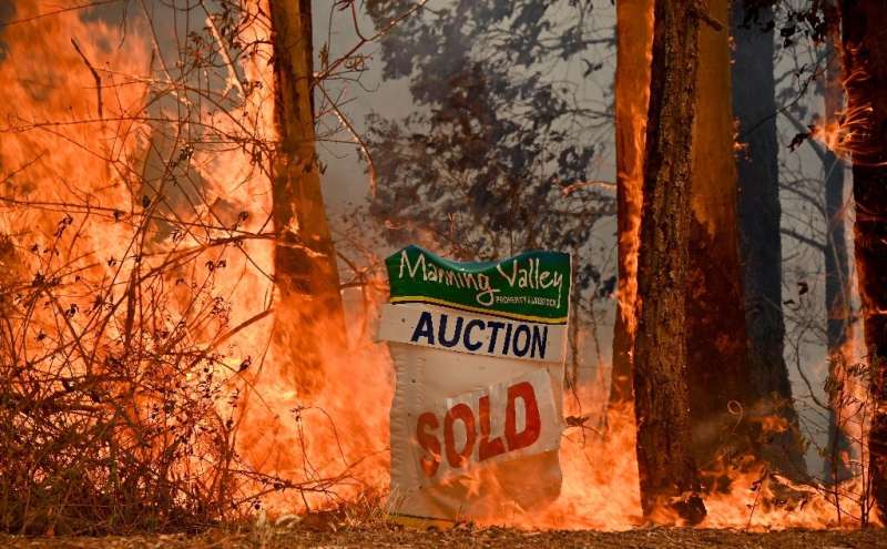 A bushfire burns outside a property near Taree