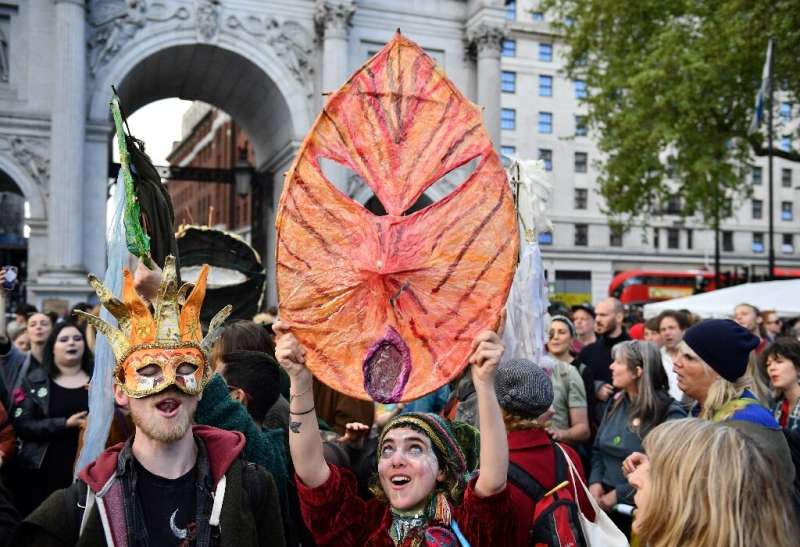 Activists sing songs in London on April 25, 2019 during the Extinction Rebellion group's protest calling for political efforts t