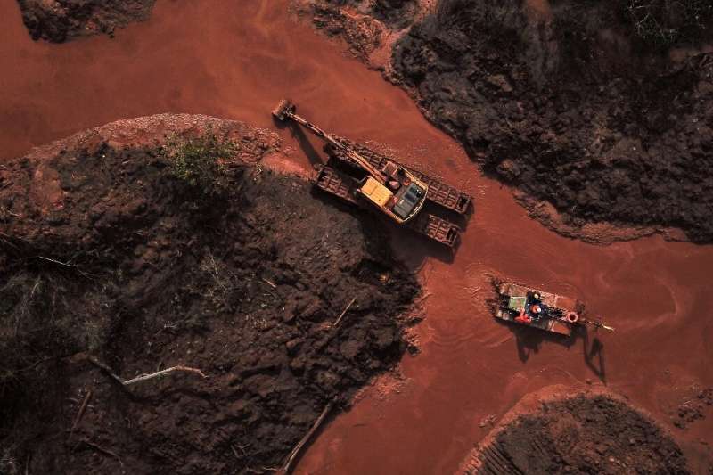 Aerial view of emergency crews picking through the mud looking for bodies, 99 days after the collapse of a tailings dam January 