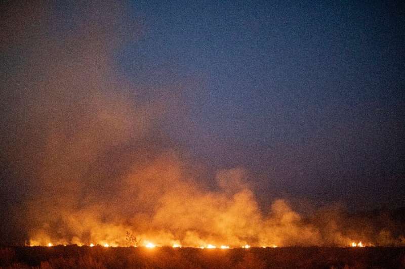 A forest wildfire spreads onto a farm in the municipality of Nova Santa Helena, in Brazil's Mato Grosso state, in the southern A