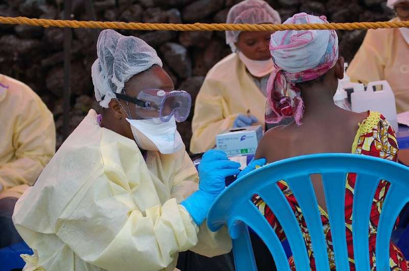 A girl receives a vaccine against Ebola from a nurse in Goma on August 7, 2019