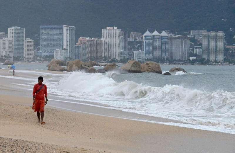 A lifeguard walks along the beach in Acapulco, Mexico on September 18, ahead of Lorena's expected arrival