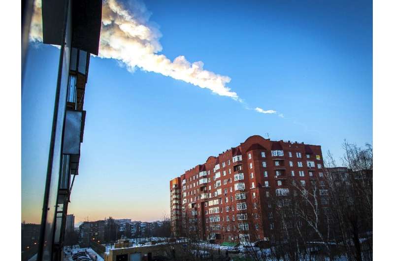 A meteorite trail is seen above a residential apartment block in the Urals city of Chelyabinsk, on February 15, 2013