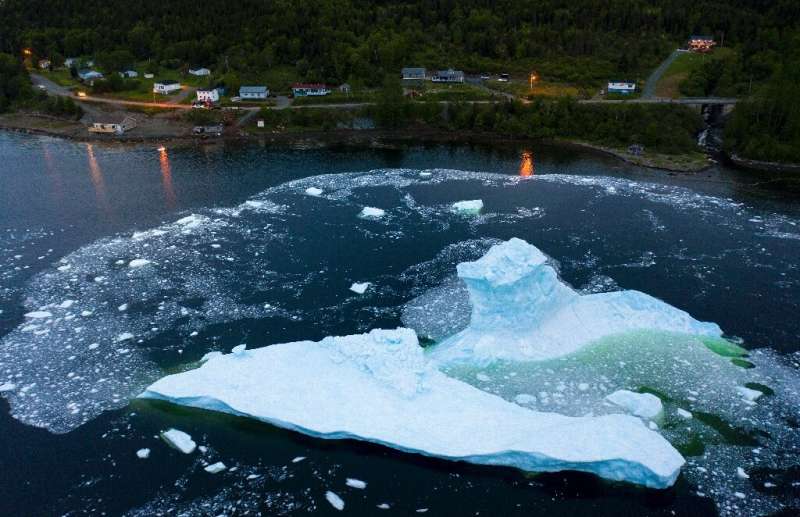 An iceberg collapses near Canada's east coast at King's Point in Newfoundland, which has a front row seat to the consequences of