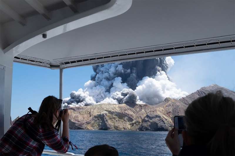 A photo courtesy of Michael Schade shows the volcano on New Zealand's White Island spewing steam and ash moments after it erupte