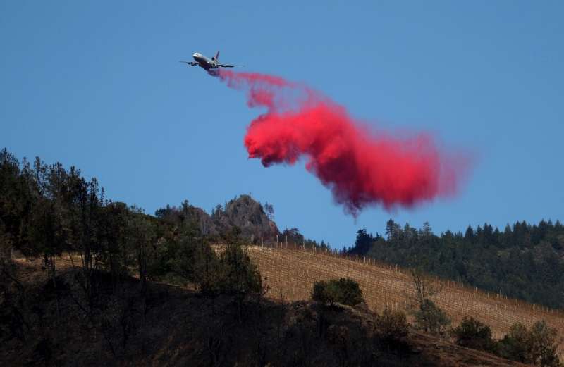 A plane drops fire retardant ahead of the Kincade Fire on October 29 in Healdsburg, California