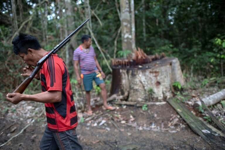 Arara indigenous chief Tatji Arara (L), 41, patrols his ancestral lands in northern Brazil, where illegal logging is a major pro
