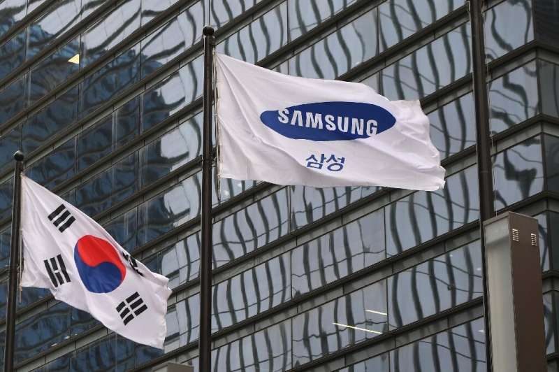 A South Korean flag flies alongside a Samsung one outside the company's headquarters in Seoul