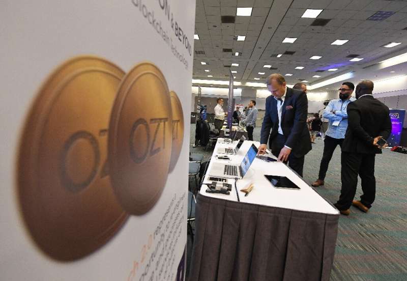Attendees confer during the Crypto Funding Summit, which helps investors understand cryptocurrency, at the Convention Center in 
