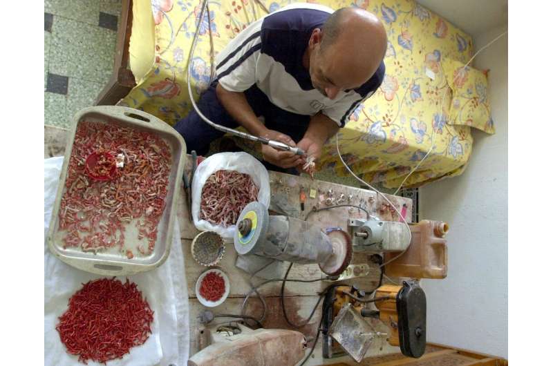 A Tunisian craftsman works legally harvested red coral