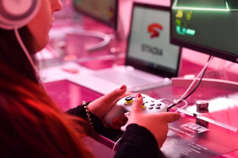 A visitor plays a game at the Google Stadia booth during the Gamescom trade fair in Cologne, Germany, on August 21