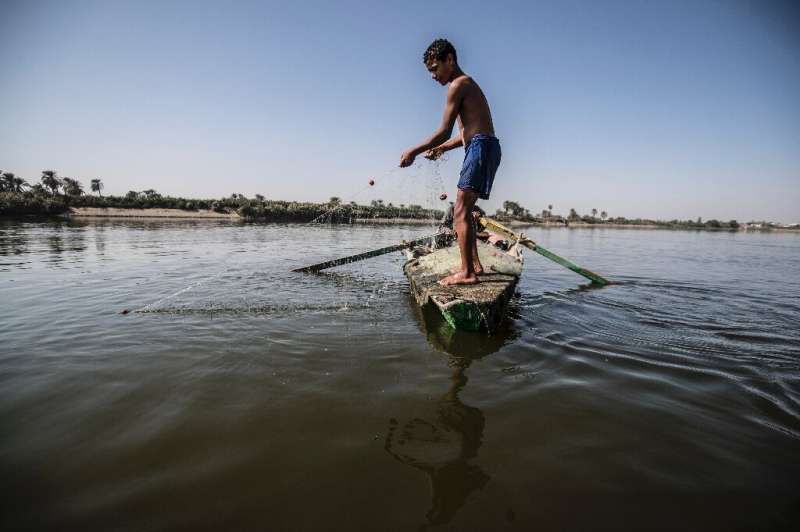 A young Egyptian fisherman pulls his net in the River Nile, south of the Egyptian capital, with Egypt suffering for years from a