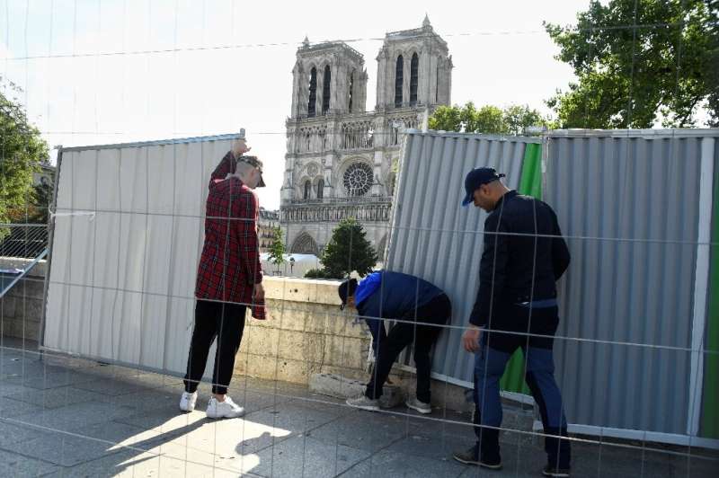Barriers were set up as a truck delivered pipes and pumps for cleaning the esplanade in front of Paris' great medieval cathedral