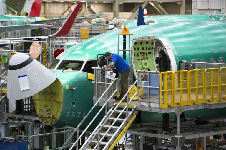 Boeing employees work on a 737 MAX jet at the company's factory in Renton, Washington—the aviation giant has unveiled a fix to t