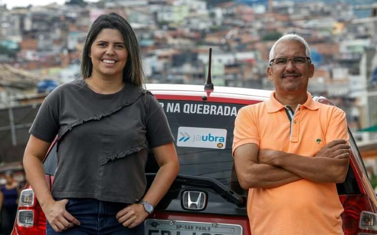 Brazilian Alvimar da Silva (R), with daughter Aline Landim, created JaUbra (Uber of slum) to serve poor Sao Paulo communities th