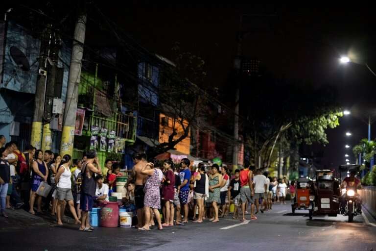 Bucket-bearing families  wait hours to fill up from tanker trucks and some hospitals to turn away less urgent cases in Manila