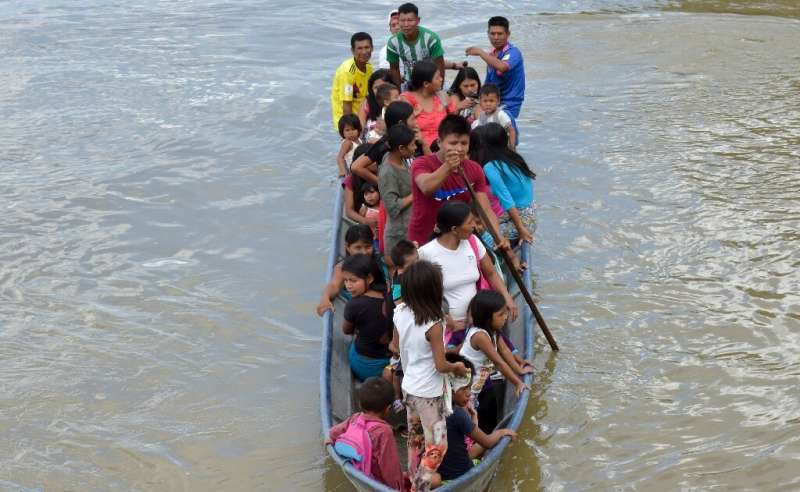 Colombian natives of the Wounaan ethnic group row towards the hospital ship San Raffaele for a checkup on the San Juan river in 