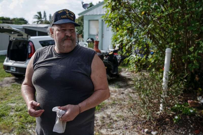 Disabled Navy veteran Joe Lewis, outside his mobile home in Jensen Beach, Florida, in an area facing mandatory evacuation orders
