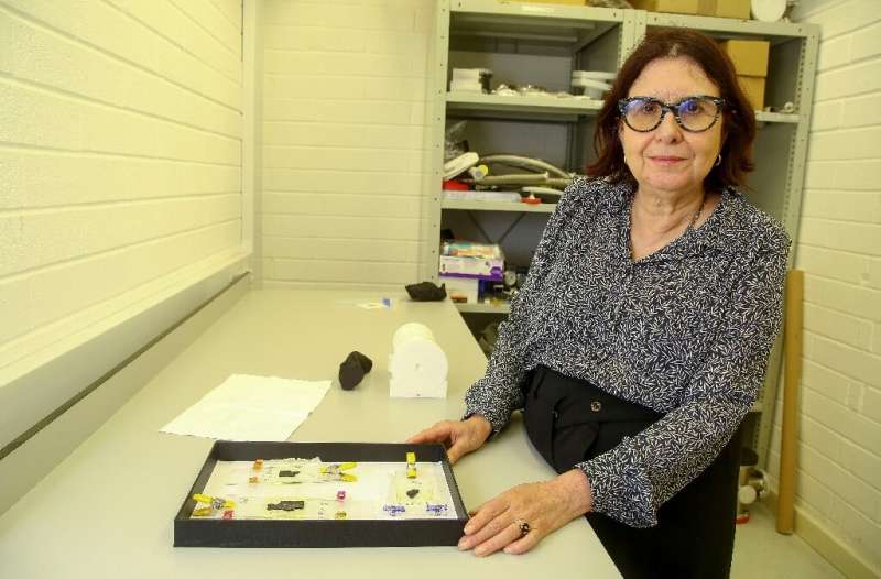 Francoise Berard, Director of the Library at the Institute de France, shows a box containing fragments of fragile Herculaneum sc