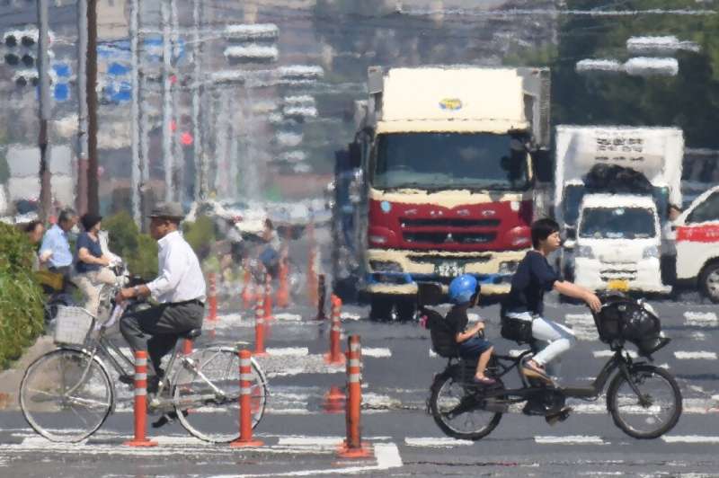 Heat haze distorts visibility during a heatwave in Tokyo - a visible phenomenon of how city infrastructure throws off heat