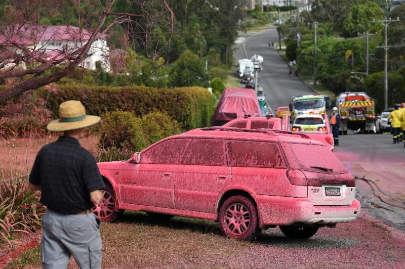 Houses and roads were caked in raspberry-red fire retardant