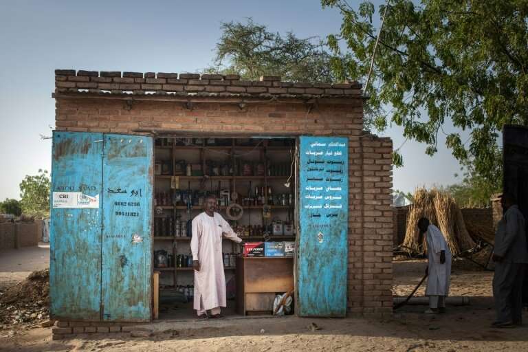 Ibrahim Hassan, 42, a Sudanese trader and refugee from Treguine camp, poses in front of his shop in Hadjer Hadid