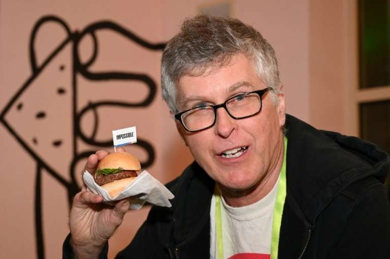 Impossible Foods CEO Pat Brown holds up an Impossible Burger 2.0, the new and improved version of the company's plant-based prod