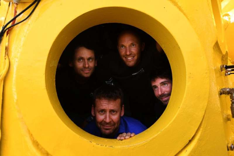 In a yellow submarine: the team of four French divers will remain inside the canary coloured capsule for an entire month