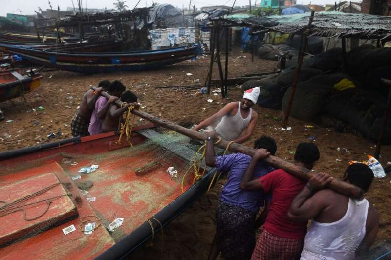 Indian fishermen secure their boats in Puri before Cyclone Fani makes landfall