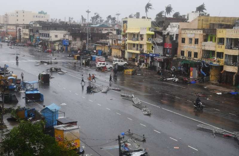 Indian residents inspect damage on a street in Puri in the eastern state of Odisha after Cyclone Fani made landfall