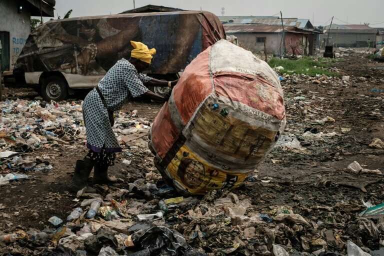 In the Mosafejo area of Lagos, plastic waste is being used to fill a swamp so that the land can be developed for housing
