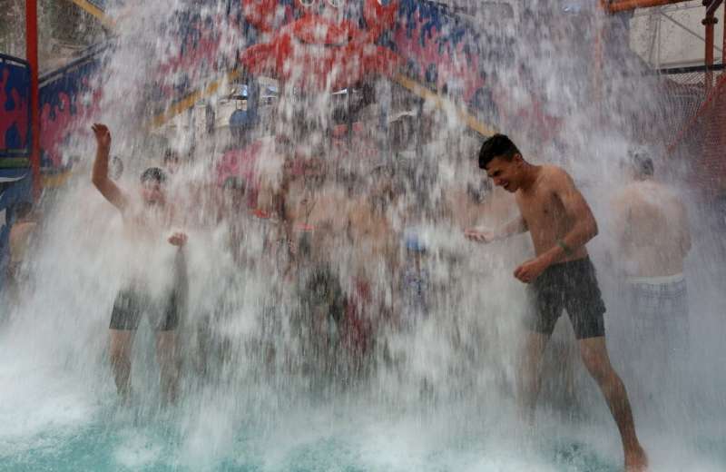 Iraqis cool themselves off at an indoor water park during a heat wave in the capital Baghdad