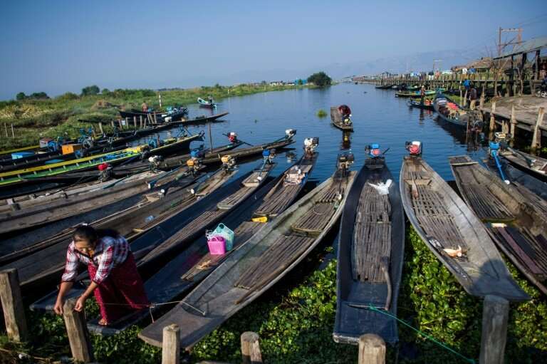 Many visitors criss-cross the lake on small wooden boats to visit stilted villages of the Intha ethnic minority