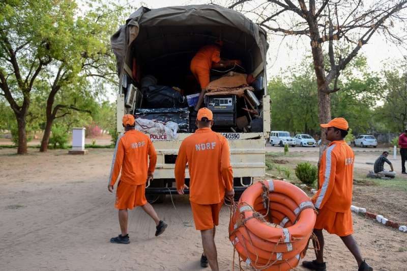 Members of India's 6th National Disaster Response Force (NDRF) load lifesaving gear onto a truck at an NDRF camp in Chiloda (als
